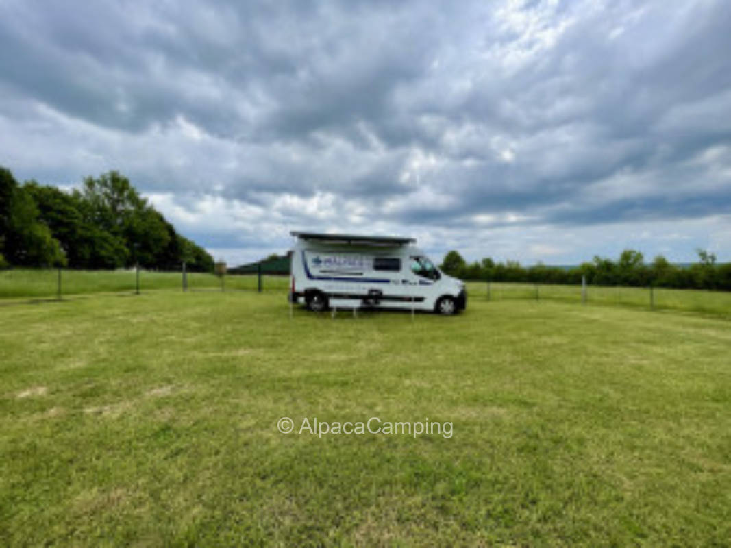 Picturesque campsite on a lush green meadow with beautiful far view #1
