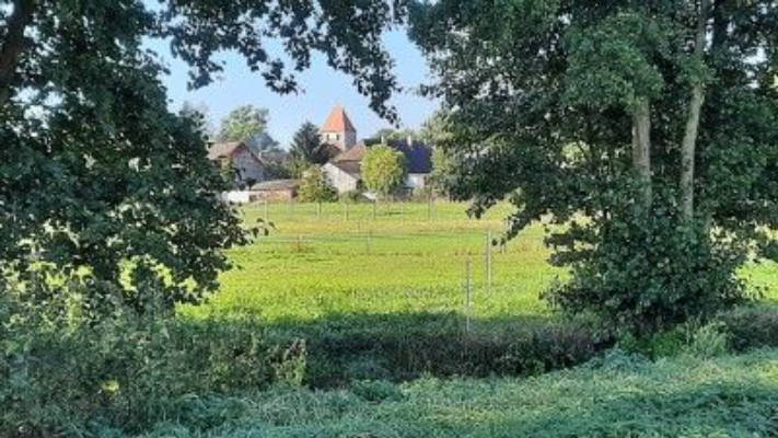 Camping on the meadow - view of a small village